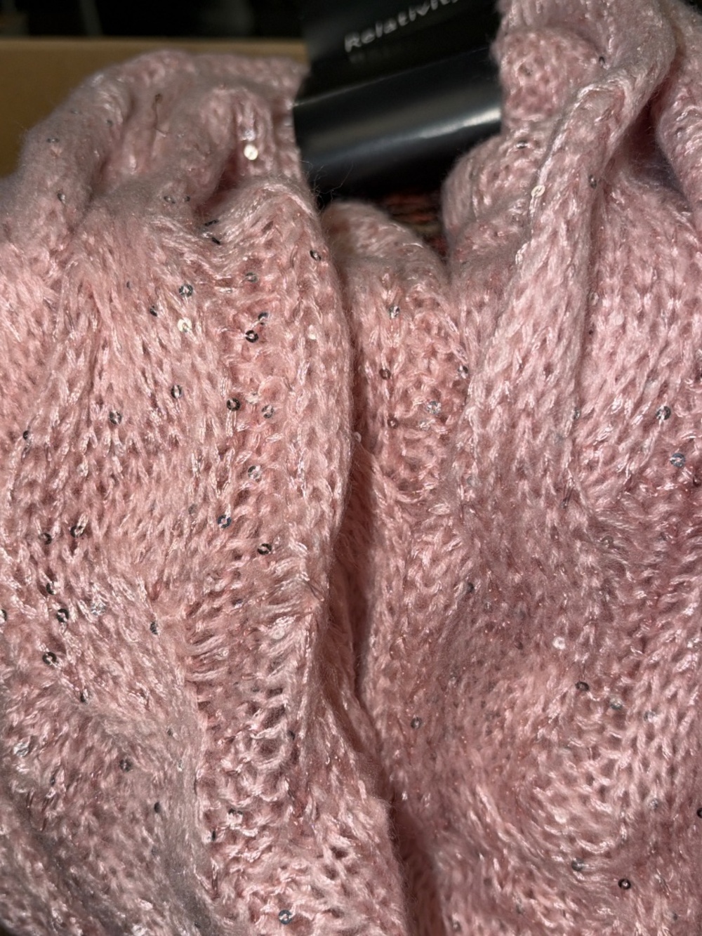 Pale pink infinity cable knit scarf.